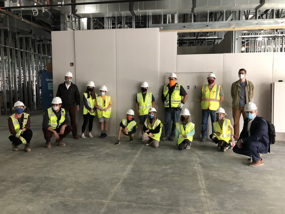 timeStudents, administrators, and construction team members pose in front of the sealed wall that will house the time capsule for the next 50 years..jpg