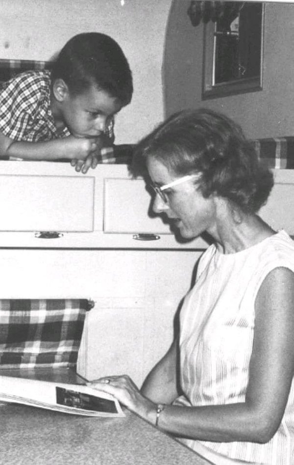 Photo courtesy of Alan Briggs Mom reading to me while on a camping trip. Photo went into the Westerville Public Opinion Newspaper in 1969.jpg