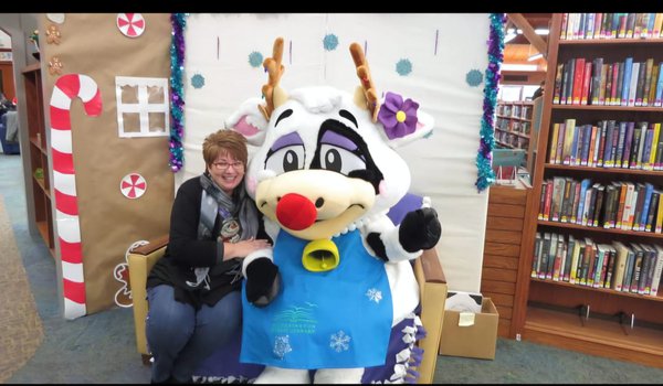 Colleen Bauman with the Pickerington Public Library's mascot, Violet the cow_Courtesy of Colleen Bauman.jpg